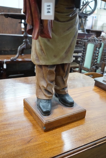 A painted composition dumb waiter in the form of an elderly butler, width 34cm, height 95cm